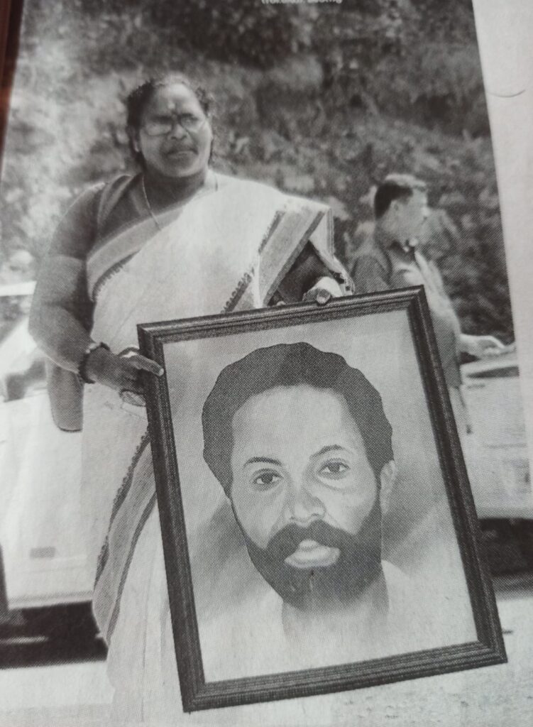 C K Janu holding the image of Jogi, who was killed in Muthanga police firing