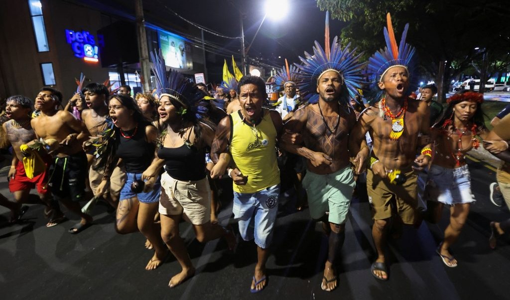 Indigenous people walk together as they participate in a demonstration on the sidelines of the UN Climate Change Conference (COP30), in Belém, Brazil, November 11, 2025.