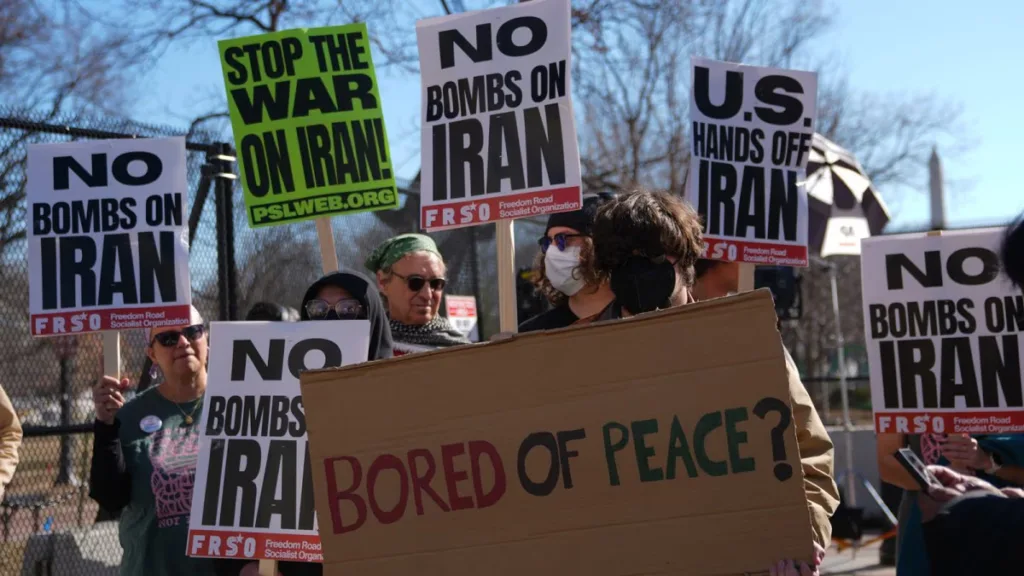 People protest near the White House against US and Israeli strikes on Iran, Saturday, Feb. 28, 2026 in Washington.