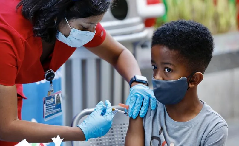 Seven-year-old Ari Alleyne receives the children's dose of the Pfizer Covid vaccine at Children's Hospital Los Angeles
