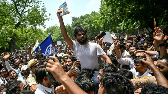 Cockroach Janta Party (CJP) founder Abhijeet Dipke (C) takes part in a protest over alleged irregularities in the country's major examinations, in New Delhi on June 6, 2026. 