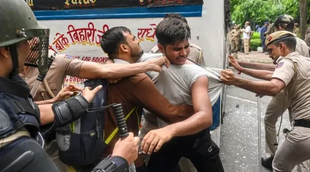 Police personnel detain protesters during a protest at Jantar Mantar demanding the resignation of Union Education Minister Dharmendra Pradhan over alleged irregularities in the NEET examination in New Delhi, Monday, July 20, 2026.
